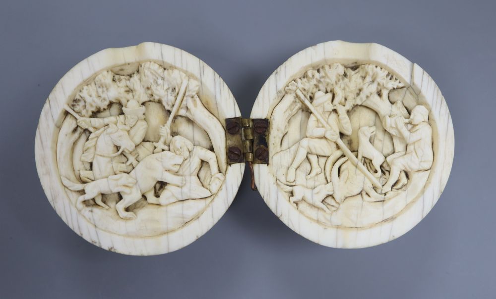 A 19th century Dieppe ivory noix ball diptych, the interior carved with hunting scenes, 5.5 diameter
